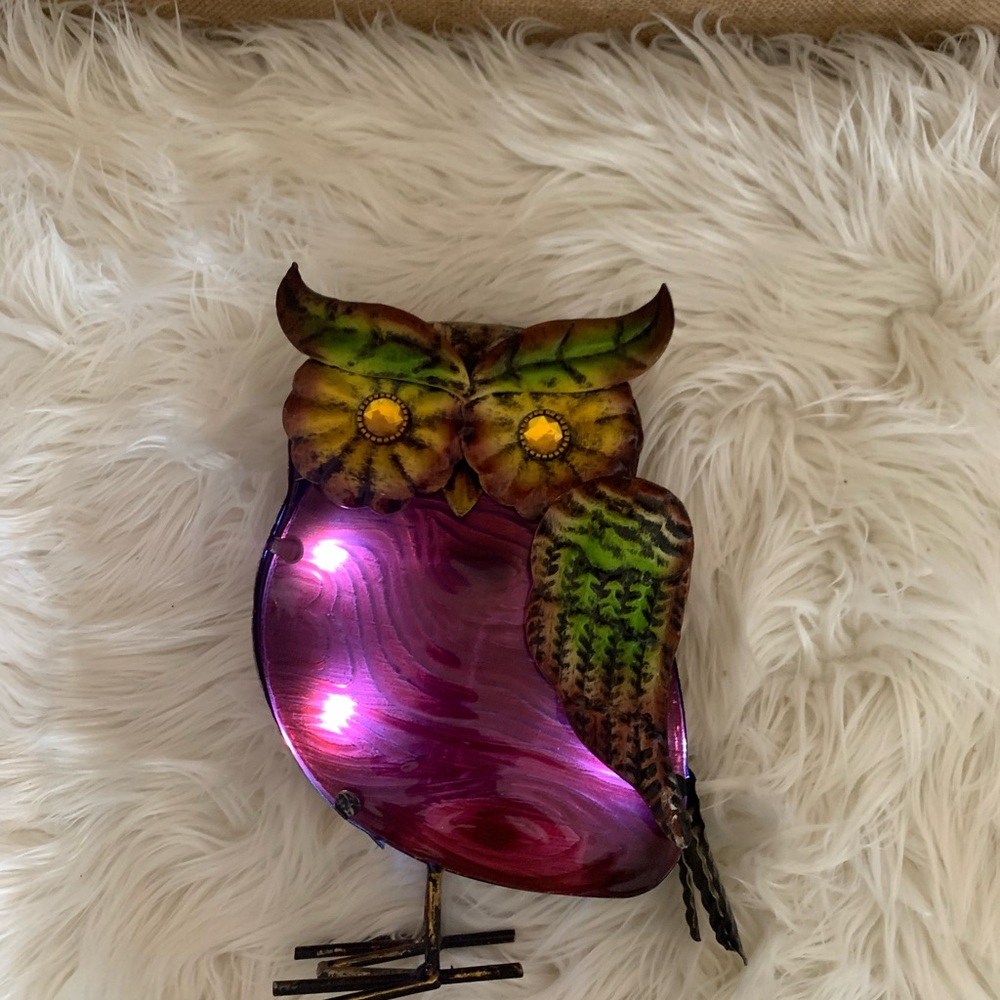Owl figurine with a metallic body, colorful wings and lights
